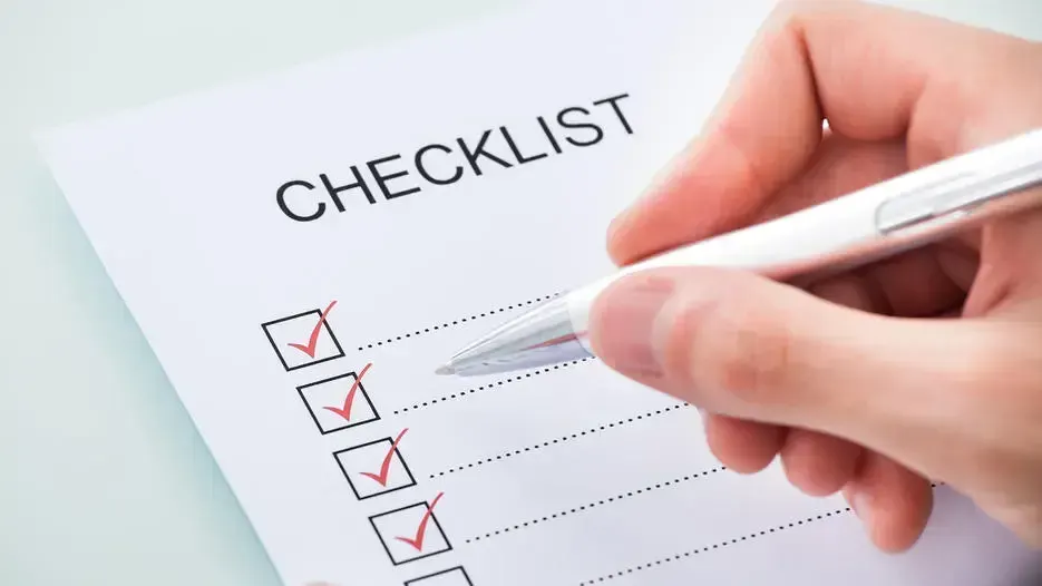 Hand ticking items on a moving checklist