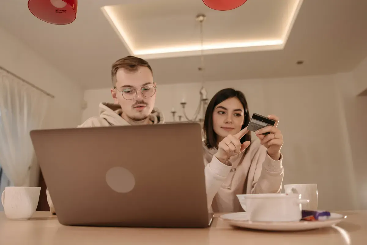 Couple comparing moving options on a laptop