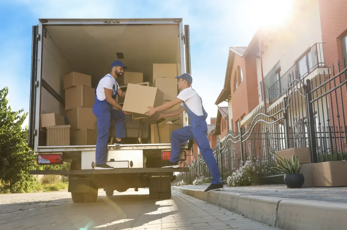Movers unloading furniture from a van