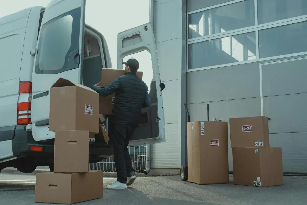 Mover loading a box into a white van