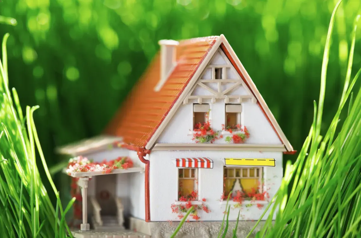 Model house surrounded by spring flowers