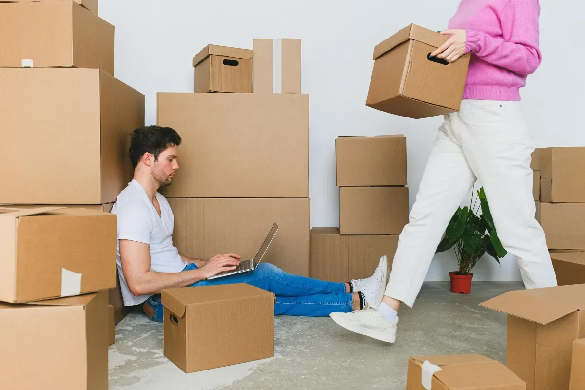People packing boxes in a living room