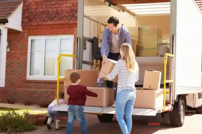 Movers stacking boxes inside a removal van