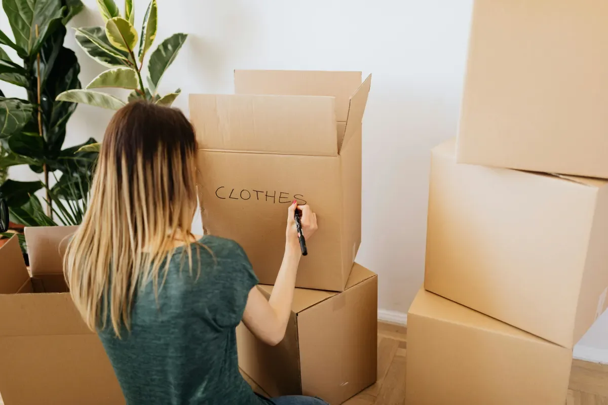 Woman packing recyclable cardboard boxes