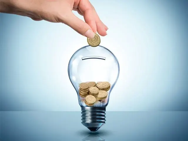 Hand holding an energy-saving light bulb