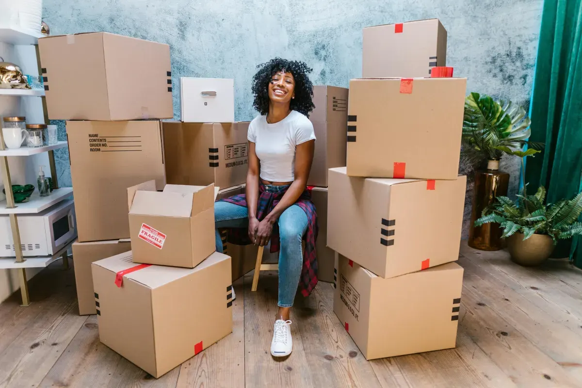 Person surrounded by packed moving boxes