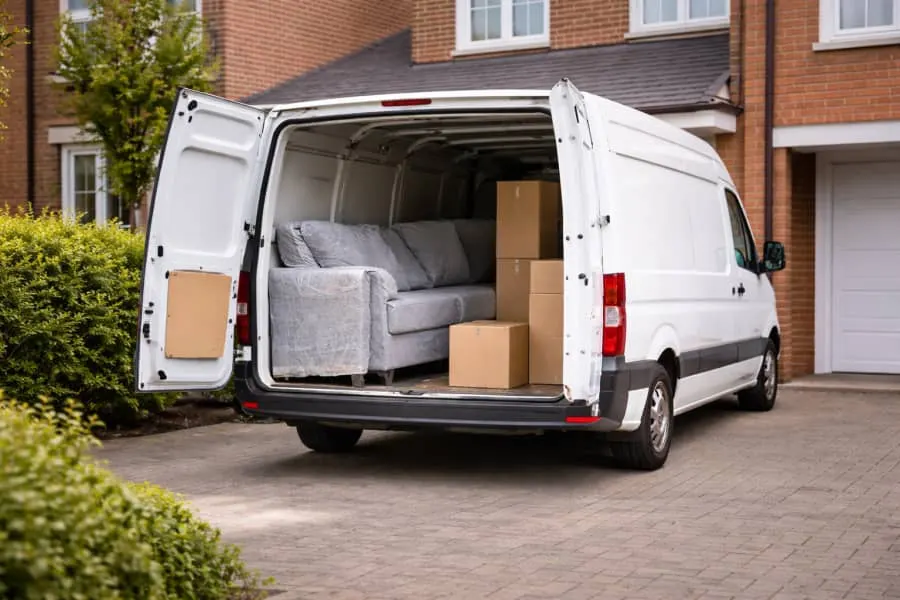 Furniture and boxes secured inside an open van